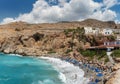 Beautiful blue lagoon with umbrellas at sandy beach, Chora Sfakion town, Crete island Royalty Free Stock Photo