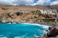 Beautiful blue lagoon with umbrellas at sandy beach, Chora Sfakion town, Crete island Royalty Free Stock Photo