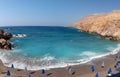 Beautiful blue lagoon with umbrellas at sandy beach, Chora Sfakion town, Crete island, Greece Royalty Free Stock Photo