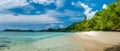 Beautiful Blue Lagoone with some Bamboo Huts, Kordiris Homestay, Palmtree in Front, Gam Island, West Papuan, Raja Ampat