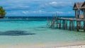 Beautiful Blue Lagoone with some Bamboo Huts, Kordiris Homestay, Palmtree in Front, Gam Island, West Papuan, Raja Ampat, Indonesia