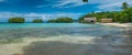 Beautiful Blue Lagoone with some Bamboo Huts, Kordiris Homestay, Palmtree in Front, Gam Island, West Papuan, Raja Ampat