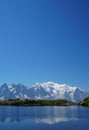 Beautiful blue lake in European alps, with Mont Blanc in the background Royalty Free Stock Photo