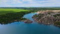 A beautiful blue lake with rocky shores overgrown with forest.