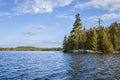 Beautiful blue lake and shoreline with pines in the Boundary Waters Canoe Area Wilderness of northern Minnesota on a bright autumn Royalty Free Stock Photo