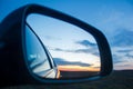 Beautiful blue landscape sunset reflect in mirror of car