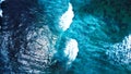 Beautiful blue and light blue sea water splash on rocky seabed beach