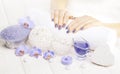 Beautiful blue manicure with orchid and towel on the white wooden table. spa Royalty Free Stock Photo