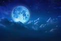 Beautiful blue moon behind cloudy on sky and star at night. Outdoors at night. Full lunar shine moonlight over cloud at nighttime Royalty Free Stock Photo