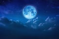 Beautiful blue moon behind cloudy on sky and star at night. Outdoors at night. Full lunar shine moonlight over cloud at nighttime