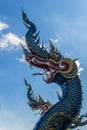 Beautiful blue naga sculpture with blue sky and white cloud on t