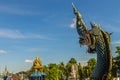 Beautiful blue naga sculpture with blue sky and white cloud on t