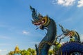 Beautiful blue naga sculpture with blue sky and white cloud on t