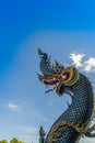 Beautiful blue naga sculpture with blue sky and white cloud on t