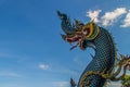 Beautiful blue naga sculpture with blue sky and white cloud on t