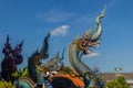 Beautiful blue naga sculpture with blue sky and white cloud on t