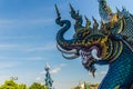 Beautiful blue naga sculpture with blue sky and white cloud on t