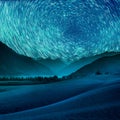 Beautiful blue night desert and dune on star trail background