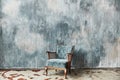 Beautiful blue old vintage chair against the background of a textured wall Royalty Free Stock Photo