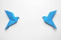 Beautiful blue origami birds on white background, flat lay. Space for text Royalty Free Stock Photo