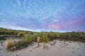 Beautiful blue and pink colors of the sun setting behind a dune, during sunset Royalty Free Stock Photo