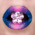 Beautiful blue and pink lips with sparkles. Pink blue lipstick. Gemstone in shape of flower, open mouth. Lip art Royalty Free Stock Photo