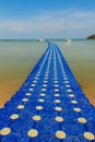 Beautiful blue pontoon made from plastic floating in the sea, rotomolding jetty, a landing stage or small pier at which boats can Royalty Free Stock Photo