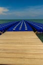 Beautiful blue pontoon made from plastic floating in the sea, rotomolding jetty, a landing stage or small pier at which boats can Royalty Free Stock Photo