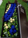 Beautiful blue roses and chocolate flower bouquet in box