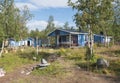 Beautiful blue sami or saami country house at Sitojaure lake shore with birch trees and flower pots. At Kungsleden Royalty Free Stock Photo