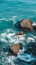 Beautiful blue sea in Nerja, Spain. Waves breaking against the rocks. Powerful stormy nature on a good day with sunny weather.