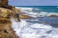 Beautiful blue sea waters and white waves sloping towards the coast