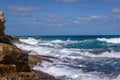 Beautiful blue sea waters and white waves sloping towards the coast