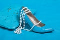 Beautiful blue shoes and handbag, pearls Royalty Free Stock Photo