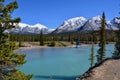 Beautiful blue Siffleur River with high mountains covered with snow in the background. Royalty Free Stock Photo