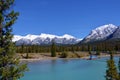 Beautiful blue Siffleur River with high mountains covered with snow in the background. Royalty Free Stock Photo