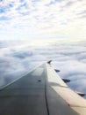 Beautiful of Blue sky above the clouds with wings of the airplane. View of Looking through the window of airplane