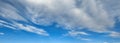 Beautiful blue sky background at daylight with white stretched bland clouds Royalty Free Stock Photo