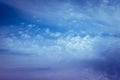 Beautiful blue sky background. Soft white clouds at sunset. Many pink, magenta and orange tones and patterns of clouds Royalty Free Stock Photo