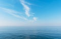 Beautiful blue sky with light white clouds. Boat cruising the sea leaving wake on a brilliant sunny day. Royalty Free Stock Photo