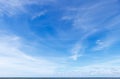 Beautiful blue sky over the sea with translucent, white, Cirrus clouds