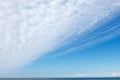 Beautiful blue sky over the sea with translucent, white, Cirrus clouds Royalty Free Stock Photo