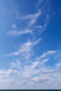 Beautiful blue sky over the sea with translucent, white, Cirrus clouds Royalty Free Stock Photo