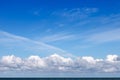 Beautiful blue sky over the sea with translucent, white, Cirrus and Cumulus clouds. Skyline Royalty Free Stock Photo