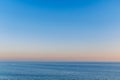 Beautiful blue sky over a slightly rippling blue sea in Ramsgate, Kent with the golden haze of a late afternoon sunset Royalty Free Stock Photo