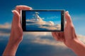 Beautiful blue sky on a screen of smartphone Royalty Free Stock Photo