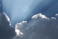 Beautiful blue sky with sun rays coming out of the clouds, heaven. White curly clouds, divine light. The rays. Royalty Free Stock Photo