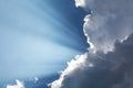 Beautiful blue sky with sun rays coming out of the clouds, heaven. White curly clouds, divine light. The rays. Royalty Free Stock Photo