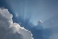 Beautiful blue sky with sun rays emerging behind the clouds Royalty Free Stock Photo