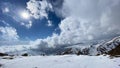 Beautiful blue sky and white clouds. Amazing view of the mountains covered with snow. Hiking in the mountains in winter Royalty Free Stock Photo